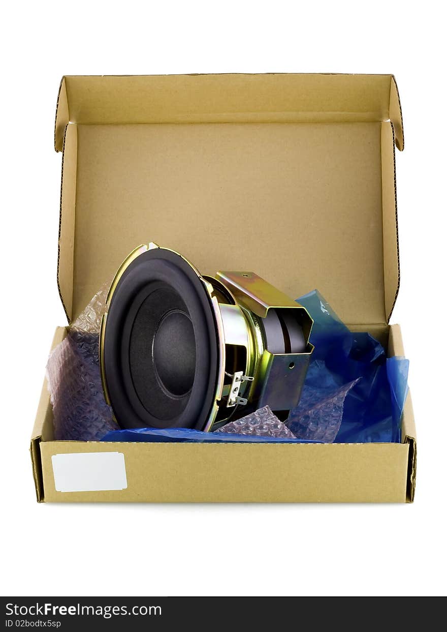 Real cardboard packing-box with electronic spare part- speaker woofer. Isolated on white. Mass production. Real cardboard packing-box with electronic spare part- speaker woofer. Isolated on white. Mass production.