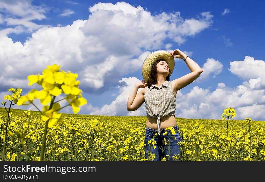 Young girl enjoying summer time on yellow field