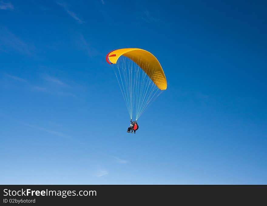 Paragliding in Bulgaria over the mountains against clear blue sky. Paragliding in Bulgaria over the mountains against clear blue sky