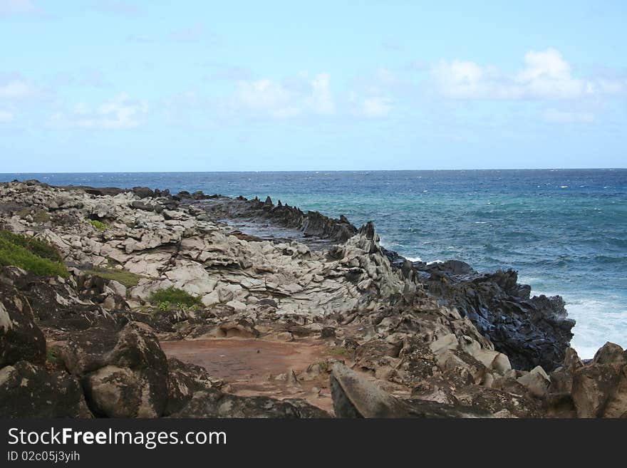 The Dragon's Teeth rock formations on the north coast of Maui, Hawaii created by ocean waves wearing away the lava rock.