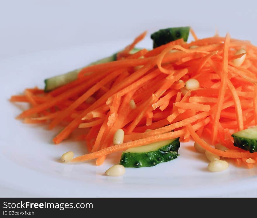 Salad with fresh carrot, cucumners and cedar nuts. Salad with fresh carrot, cucumners and cedar nuts.