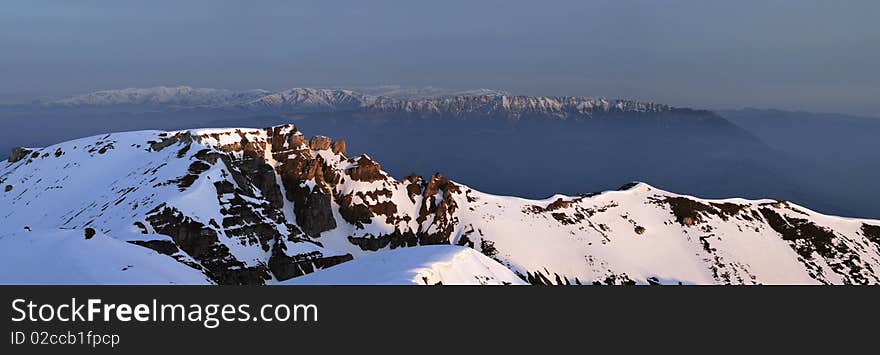 Panoramic Picture with sunrise in Carpathians Mountain, Romania, Bucegi Summit, from Vf.Omu Peak, and Piatra Craiului Mountain far away. Panoramic Picture with sunrise in Carpathians Mountain, Romania, Bucegi Summit, from Vf.Omu Peak, and Piatra Craiului Mountain far away.