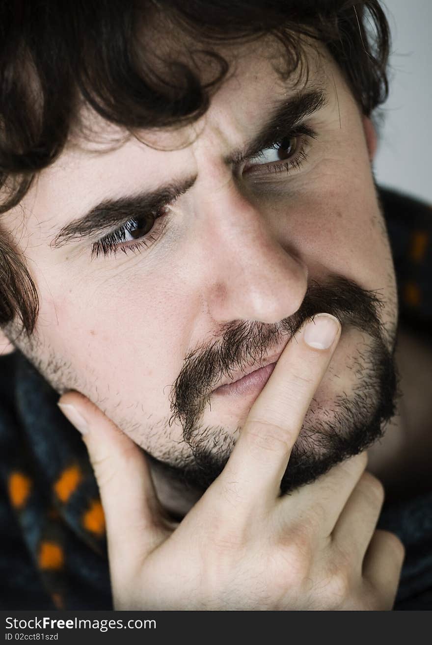 Close up portrait of thoughtful young man