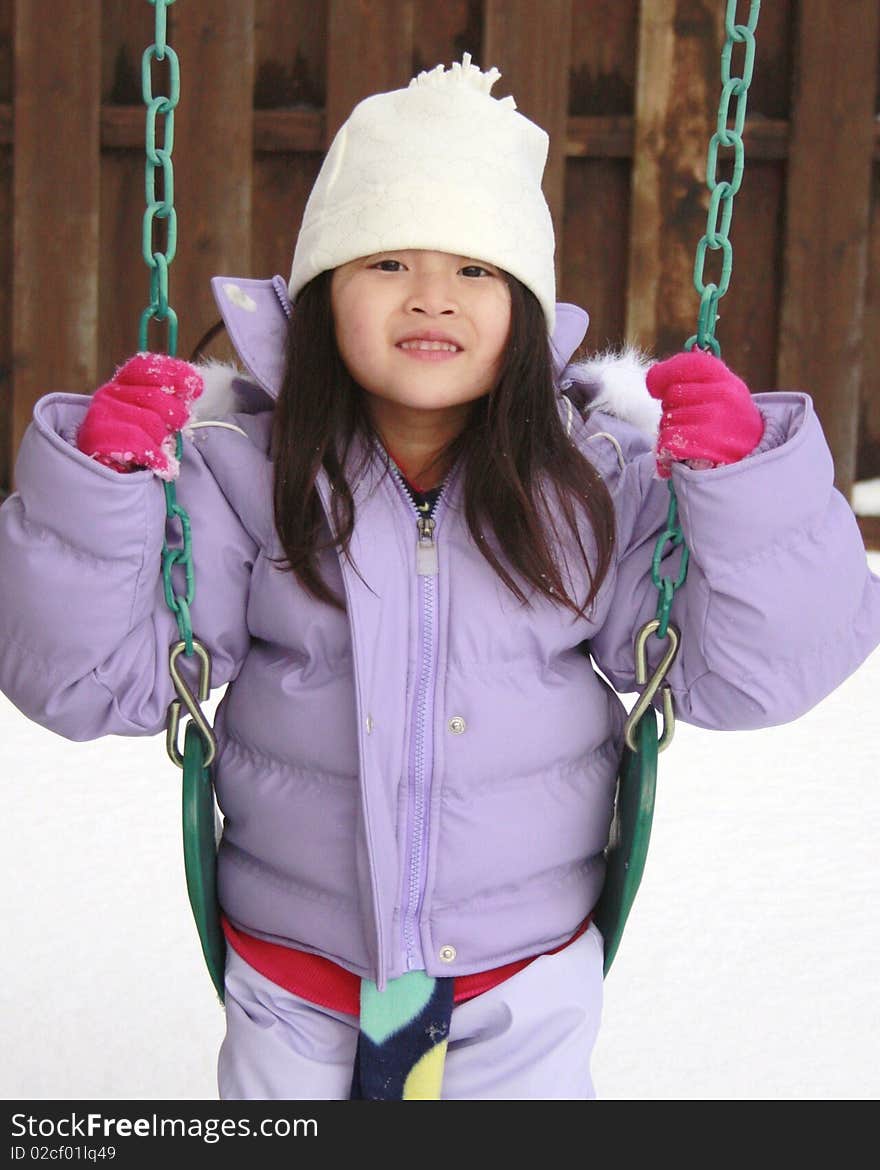 Little asian girl playing in the snow. Little asian girl playing in the snow