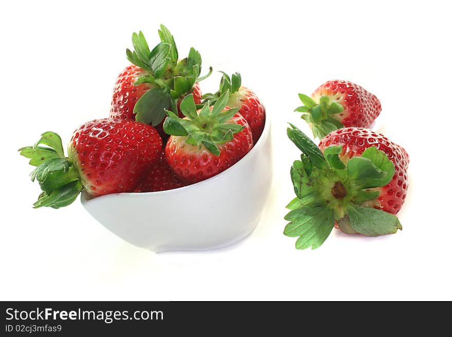 Strawberries in a bowl on a white background