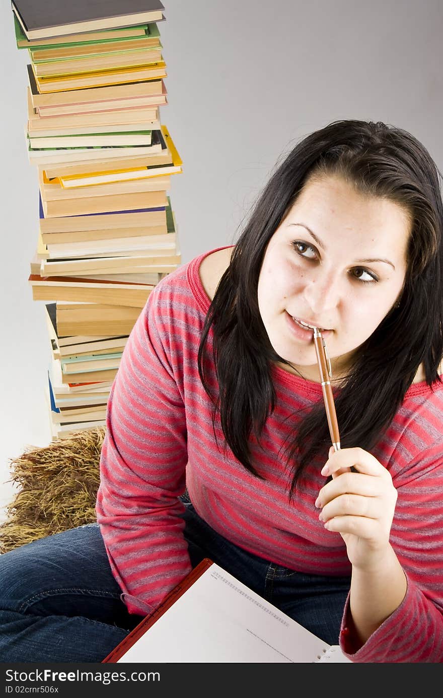 Portrait of natural young girl when taking a break while learning studying with pencil in mouth