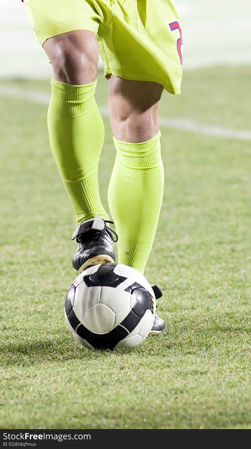 Soccer player with his foot on the ball