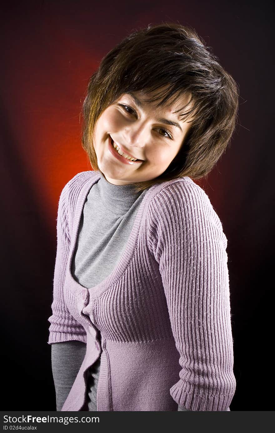 Young beautiful smiling girl on dark background