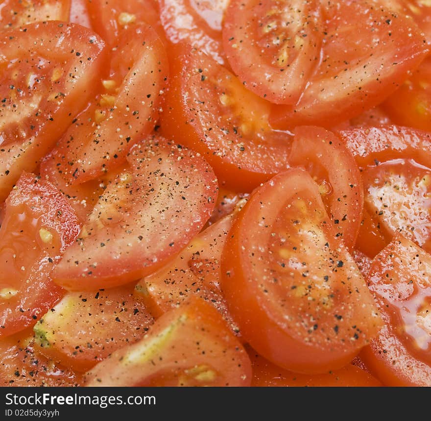 Sliced tomatos with salt and pepper background