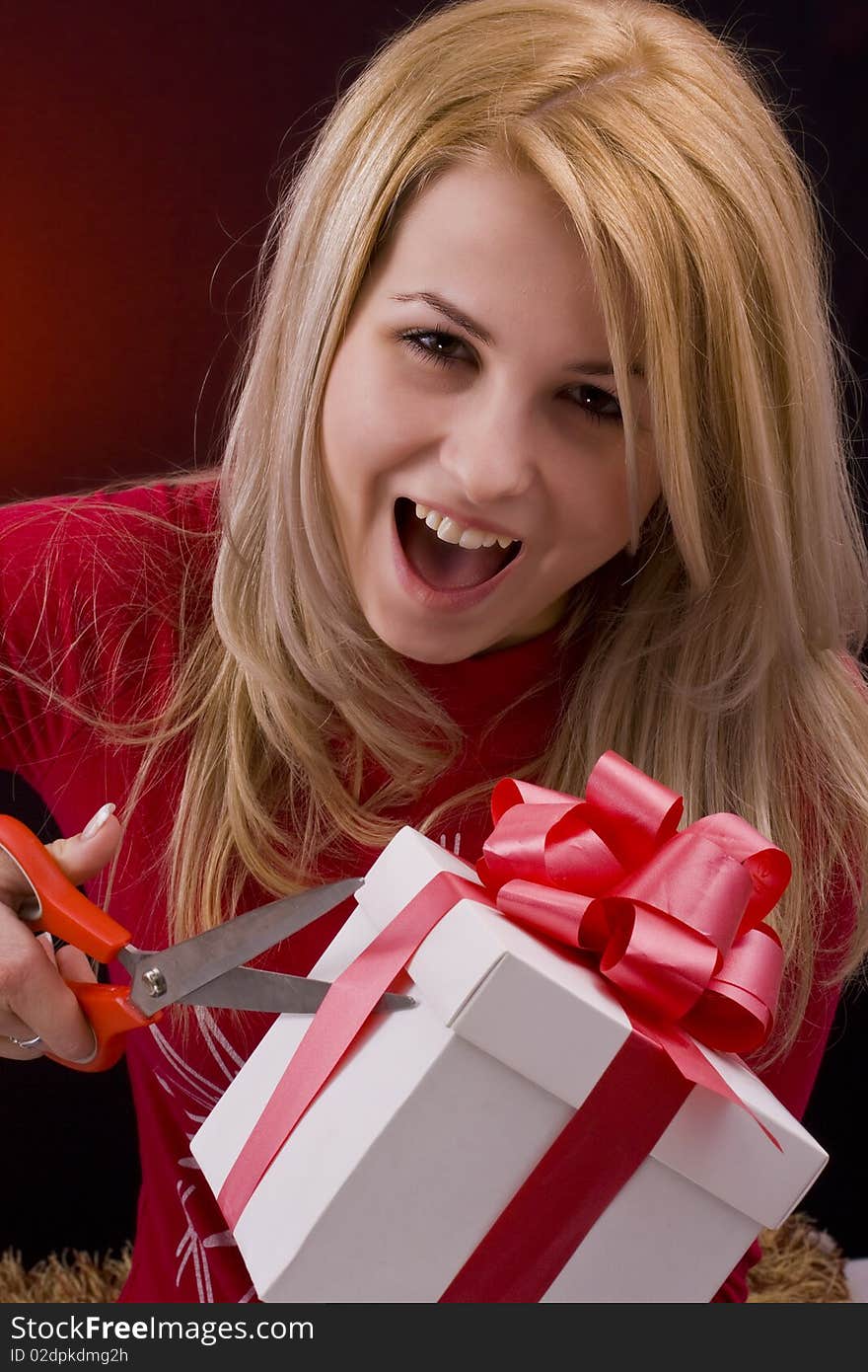 Girl holding a gift and smiling. Girl holding a gift and smiling