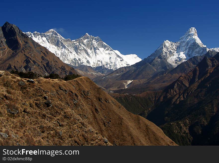 Ama Dablam peak 6812m on the right, Everest and Nuptse on the left, photographed in high Himalaya, Nepal. Ama Dablam peak 6812m on the right, Everest and Nuptse on the left, photographed in high Himalaya, Nepal