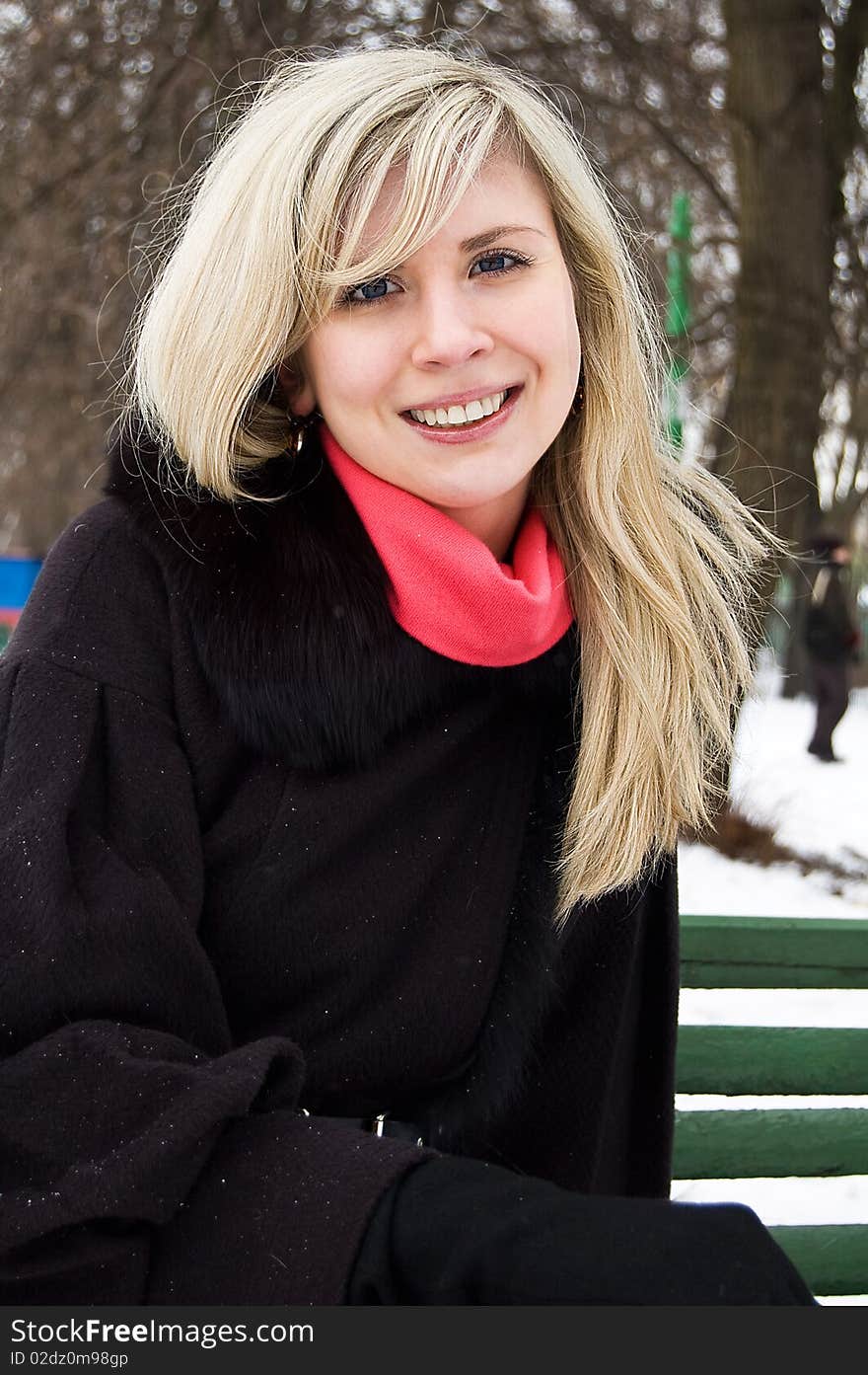 The smiling girl on a bench