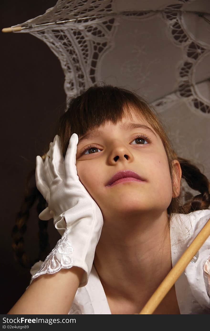 Planned girl with the retro umbrella on the brown background. Planned girl with the retro umbrella on the brown background