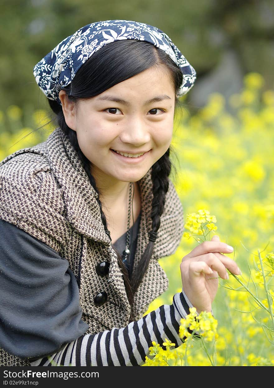 and beautiful young happy woman. In the yellow flower background. and beautiful young happy woman. In the yellow flower background