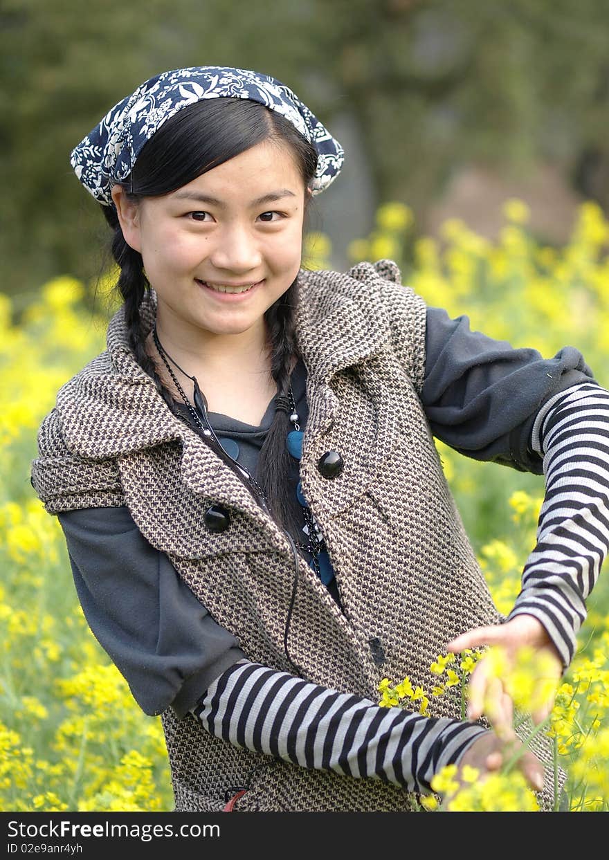 and beautiful young happy woman. In the yellow flower background. and beautiful young happy woman. In the yellow flower background