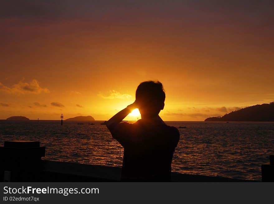 Silhouette of tourists taking photos of sun set. Silhouette of tourists taking photos of sun set