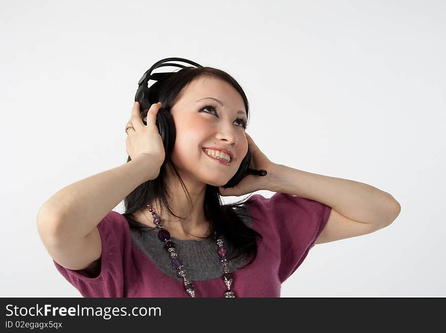 Attractive smiling woman with headphones on white background