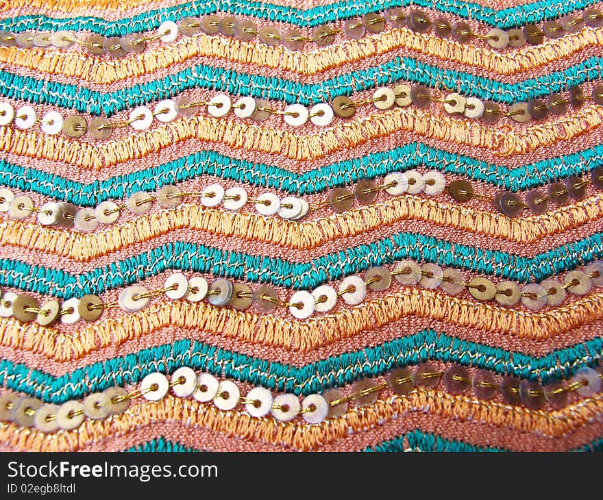 A designer fabric with zigzag thread and sequence work used for manufacturing designer attires.