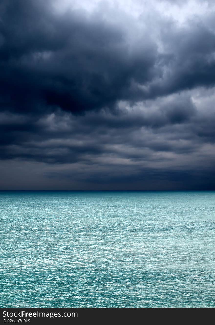 Dark clouds over turquoise sea. Dark clouds over turquoise sea.