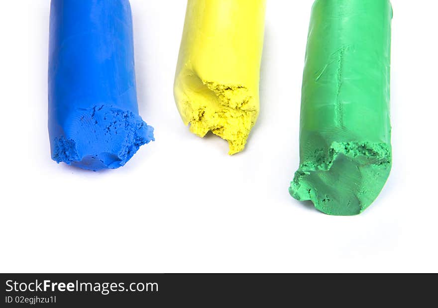 Colored plasticine on white background