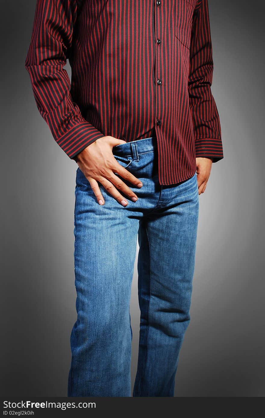 Beautiful blue jeans and red shirt wearing a model isolated on a gray background.