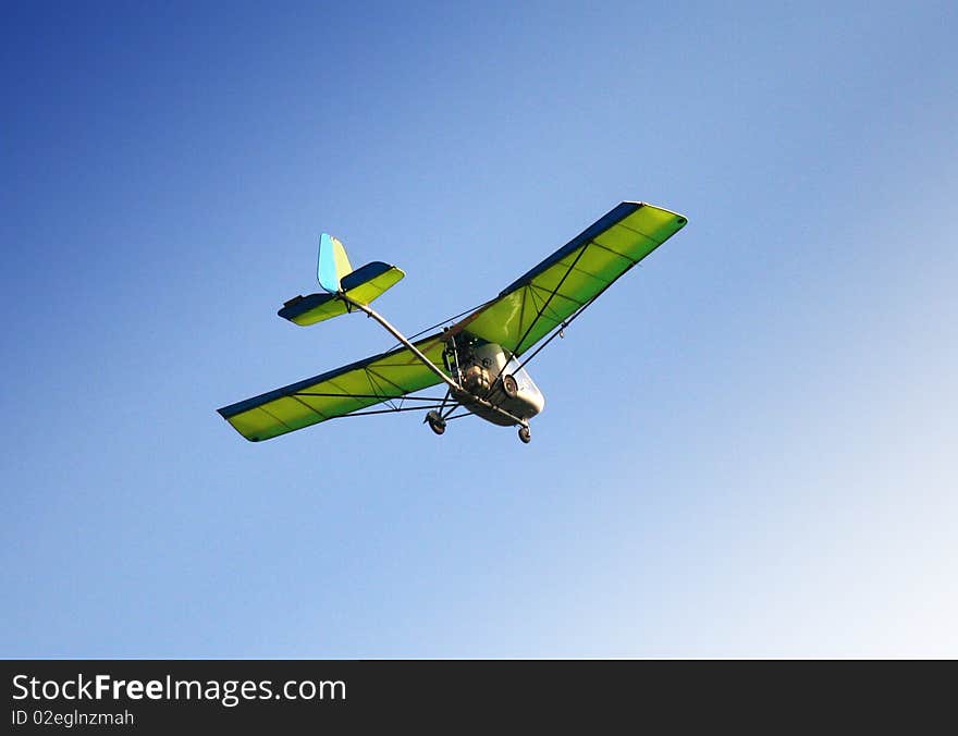 Motor gliding green flight in blue sky. Motor gliding green flight in blue sky
