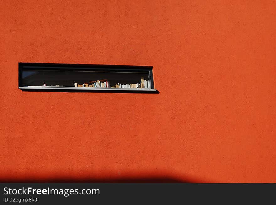 Modern window with books and a small shadow