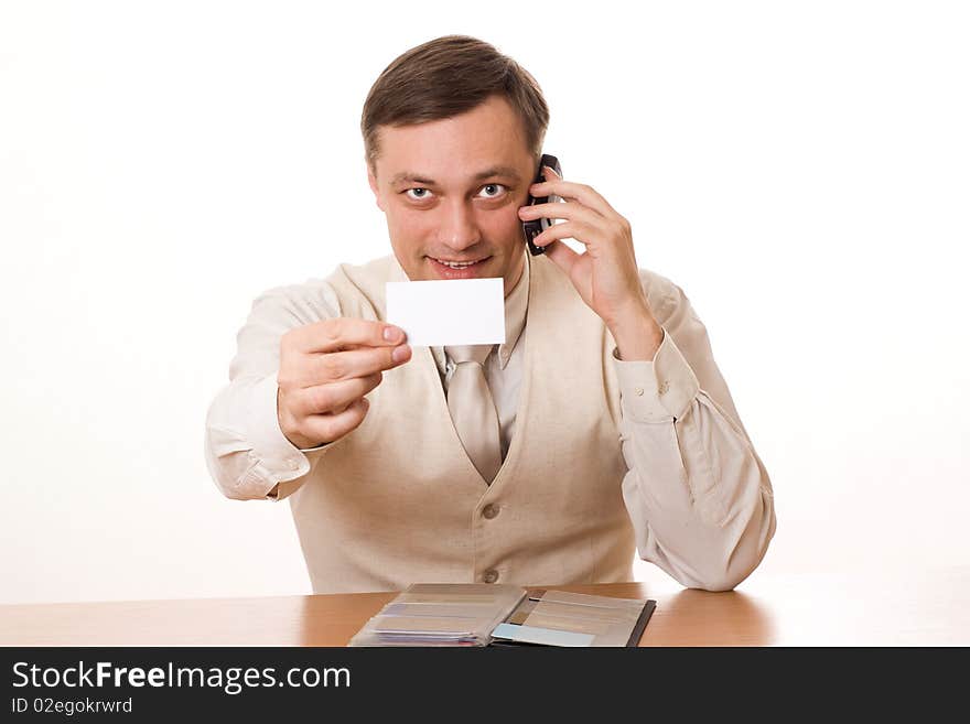 Businessman talking on the phone at the table on a white