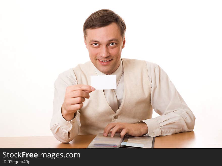 Handsome young businessman shows the business card on a white background