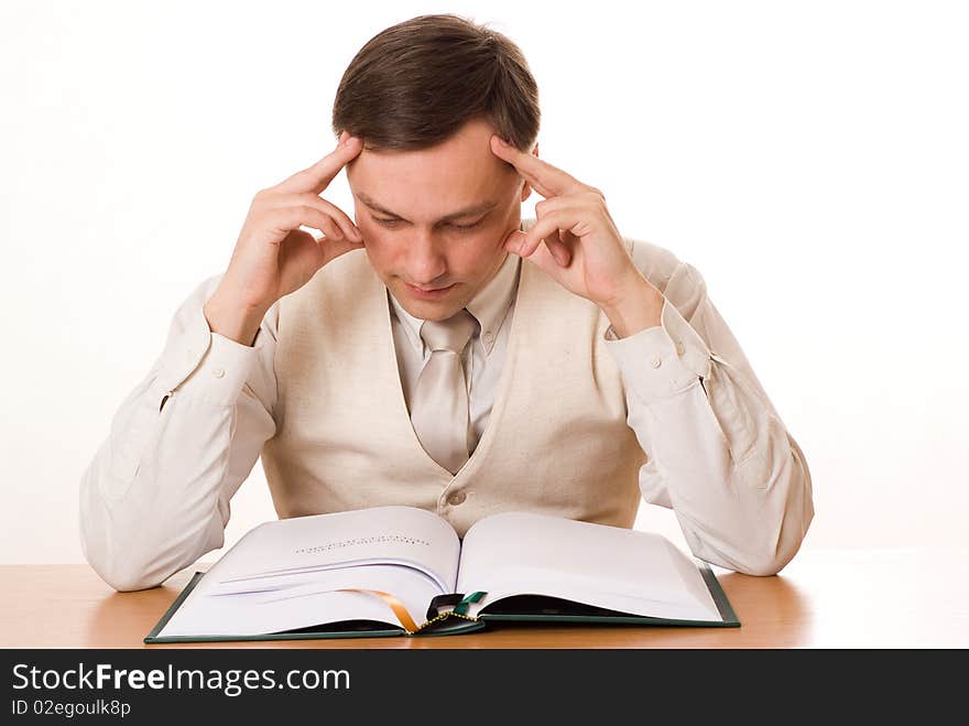 Young handsome businessman reading a book on white background