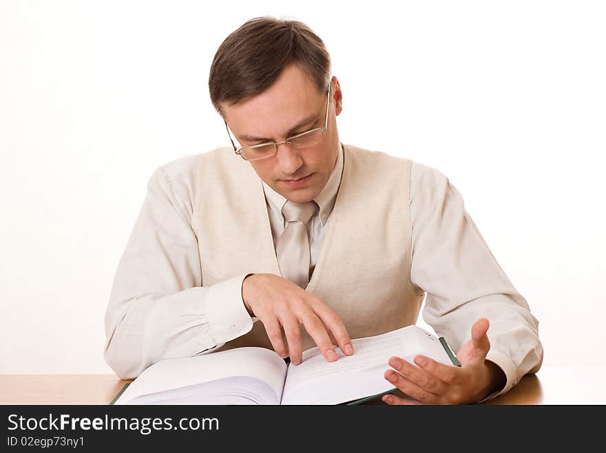 Handsome businessman reading a book on white