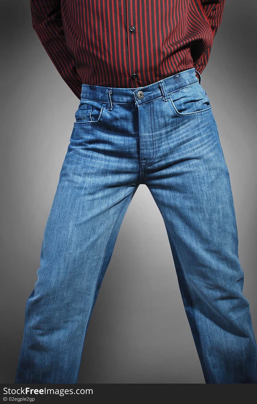 Beautiful blue jeans and red shirt wearing a model isolated on a gray background.