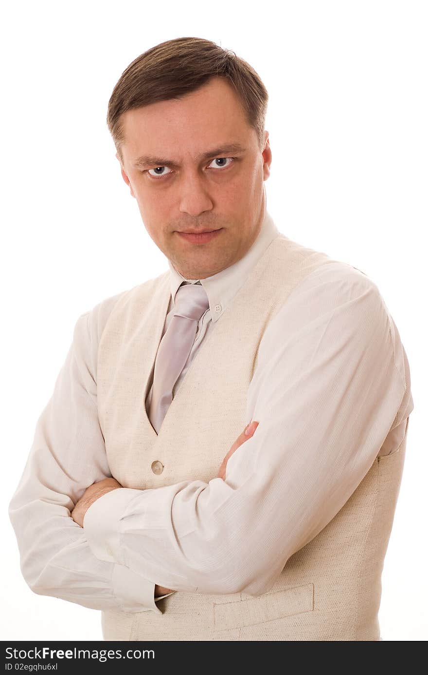 Handsome young serious businessman standing on white background