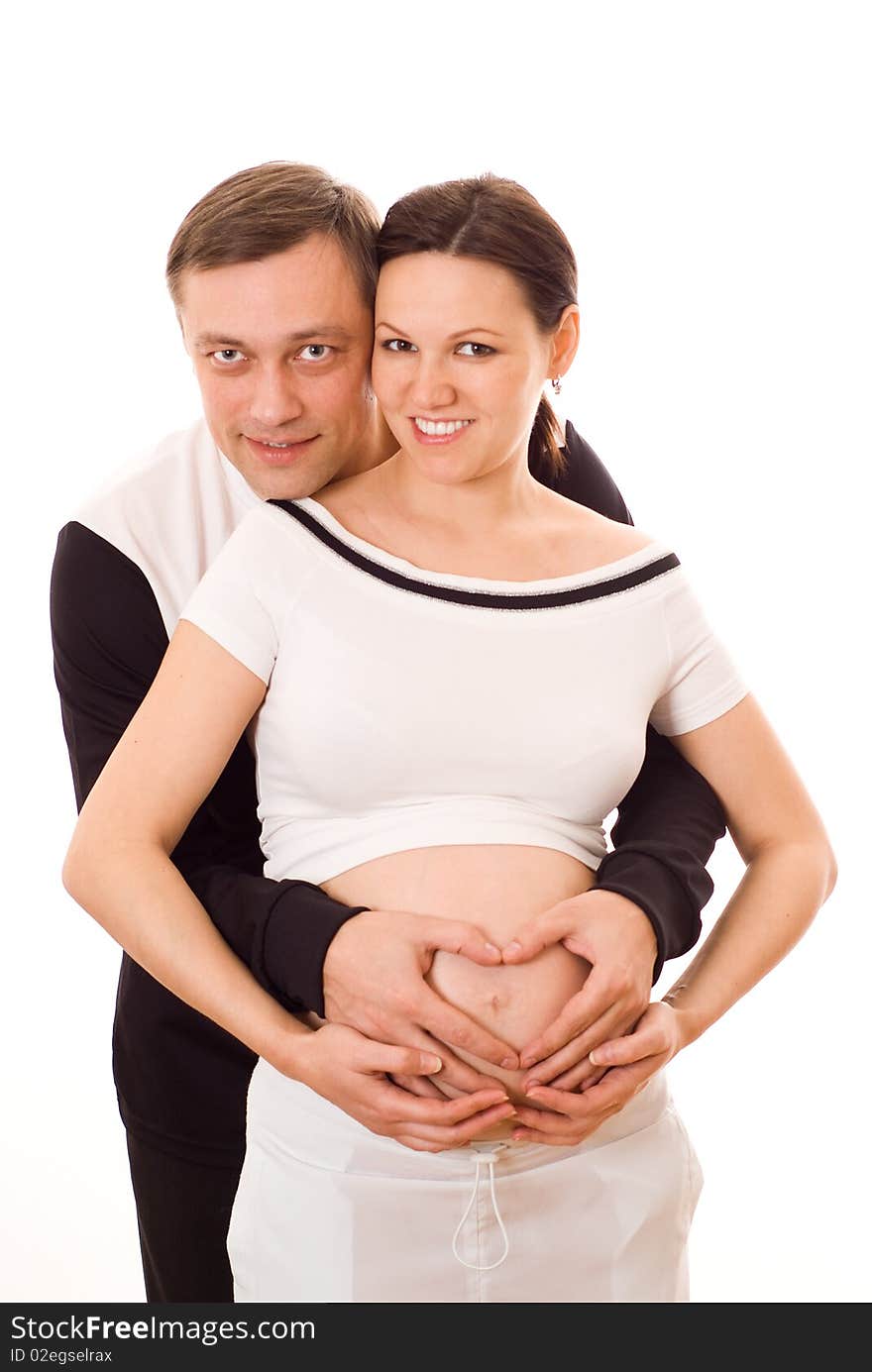 Pregnant woman standing next to her husband