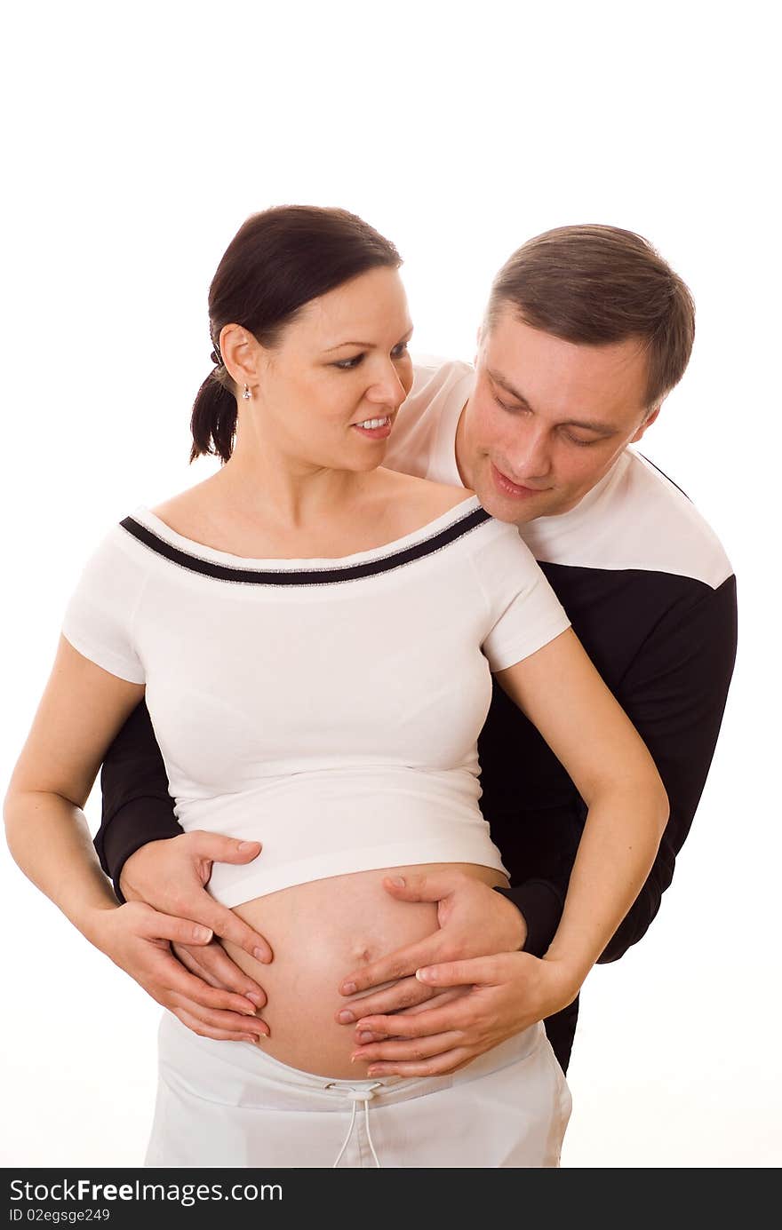 Young pregnant woman standing next to her husband