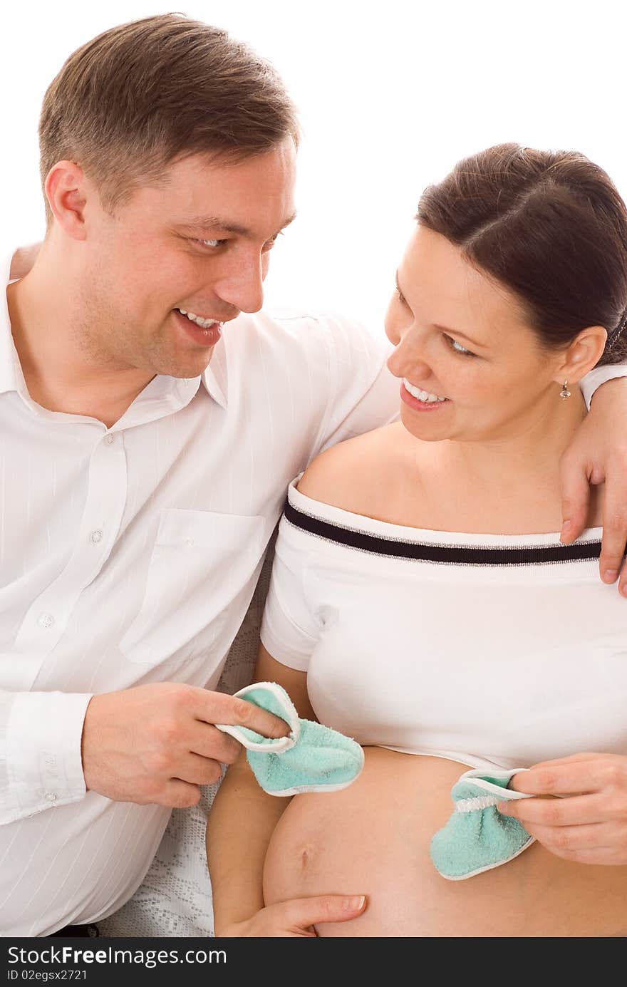 Young man with his wife were sitting on a white background. Young man with his wife were sitting on a white background