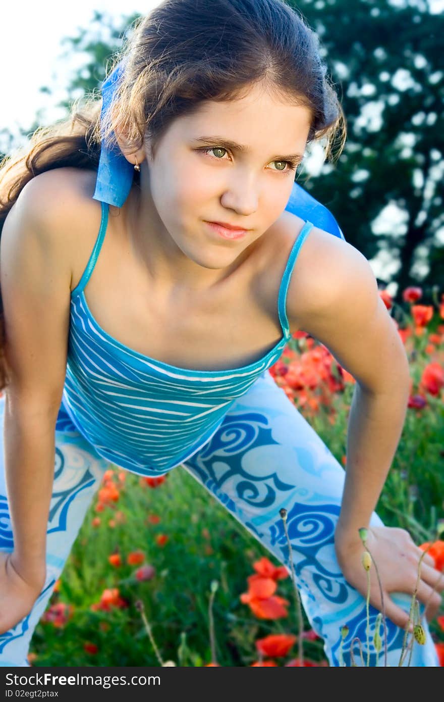 Portrait teen girl with poppy on nature