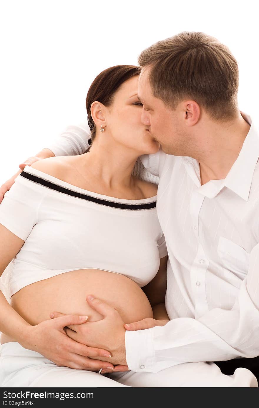 Man with his pregnant wife on a white