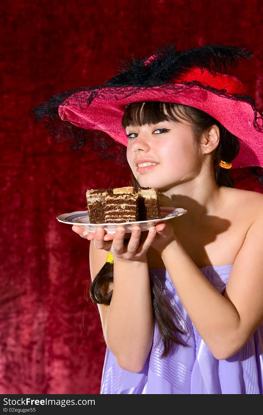 Lovely teen girl in dress and hat with cake. Lovely teen girl in dress and hat with cake