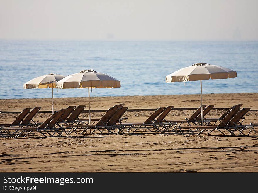 Sunbeds are waiting for tourists on the beach