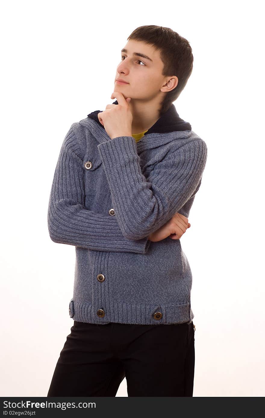 Handsome young man stands and thinks on a white