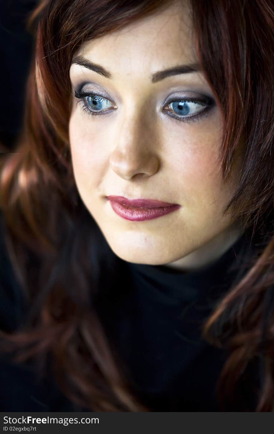 Closeup Portrait of handsome woman with blue eyes looking to the side