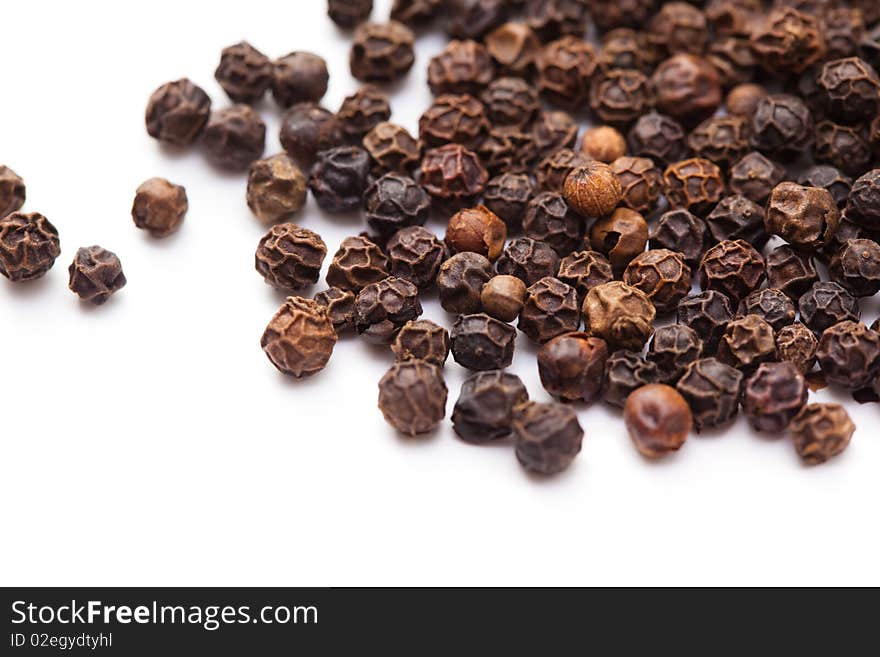 Close up of black peppercorns in isolated white background. Close up of black peppercorns in isolated white background