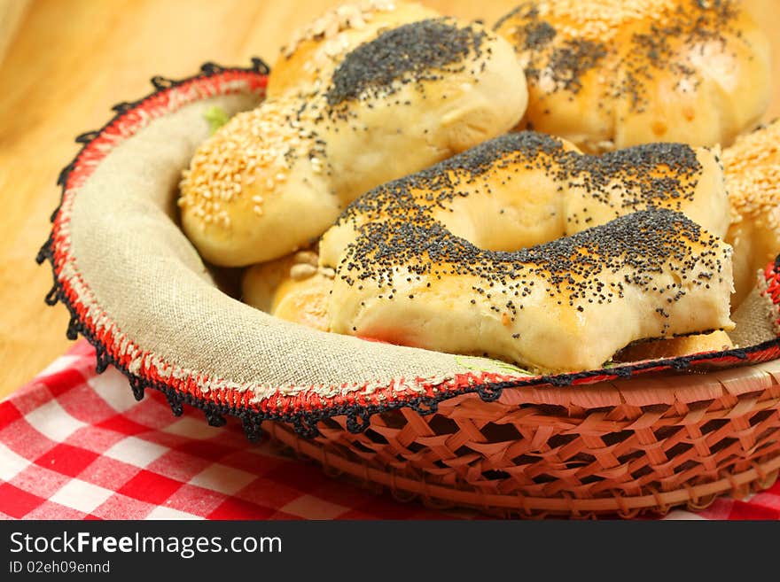 Fresh different kinds of bread rolls covered with seeds in basket. Fresh different kinds of bread rolls covered with seeds in basket.