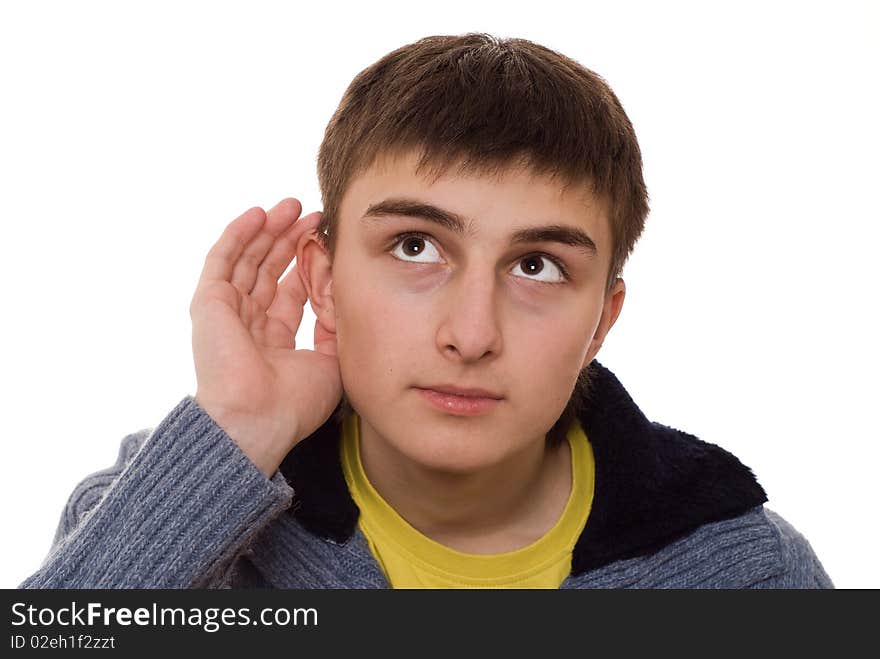 Beautiful teenager in a blue blouse listens on a white background. Beautiful teenager in a blue blouse listens on a white background