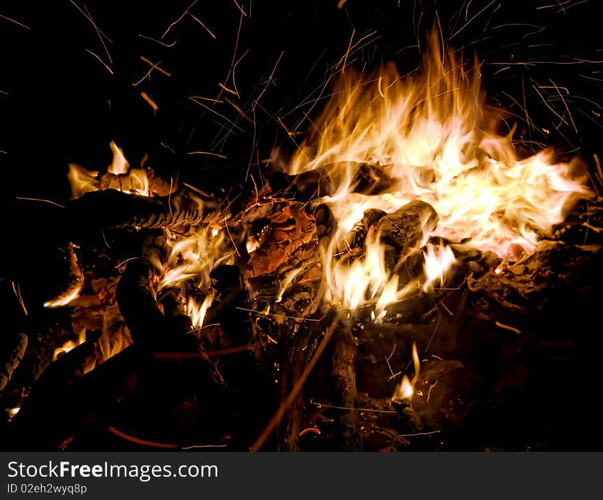 Nature campfire with flying sparks and firewood. Nature campfire with flying sparks and firewood