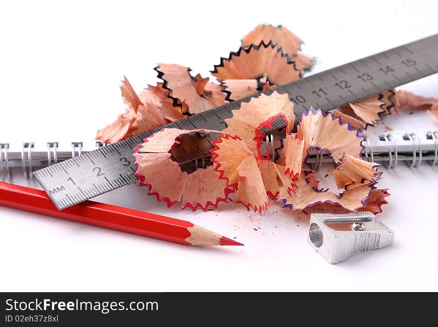 Open spiral notebook with pencil and sharpener.