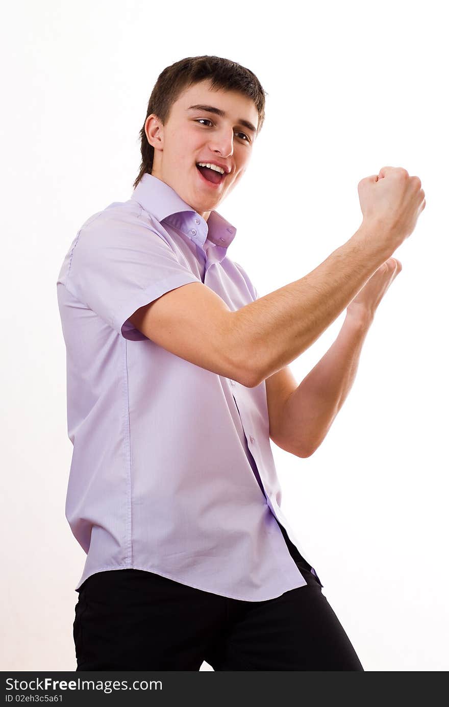 Happy teenager in a purple shirt against a white