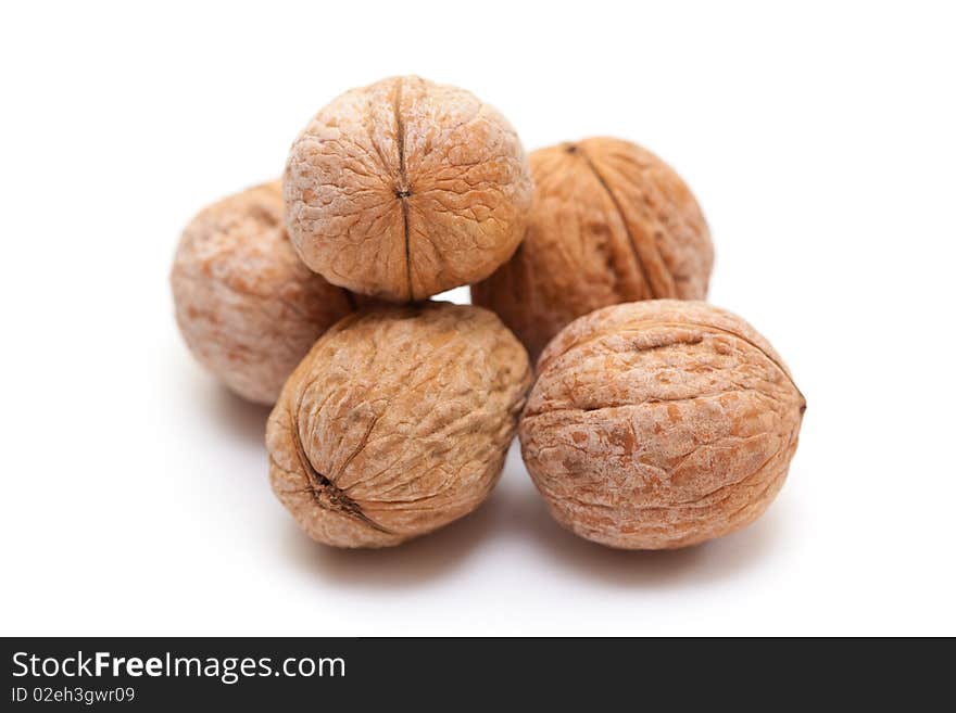 Close-up of a walnut against white background. Close-up of a walnut against white background