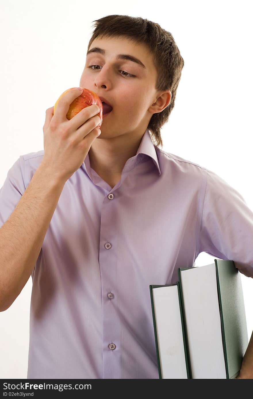 Handsome young student eats an apple